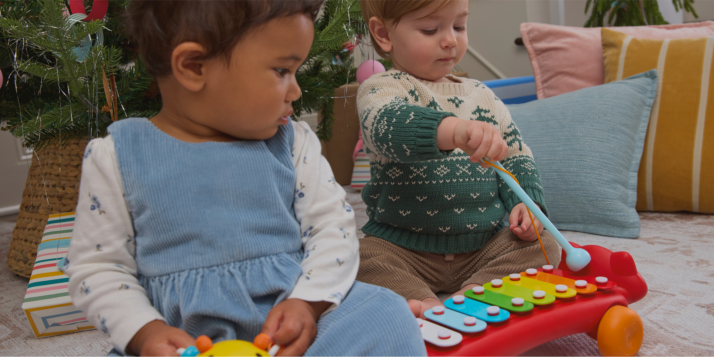 Two babies playing with toys