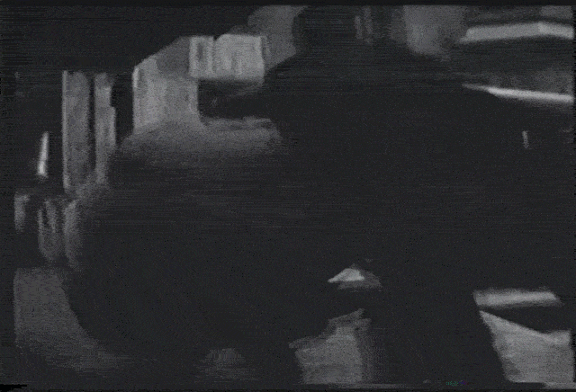 Vintage black-and-white film clip of an early OshKosh delivery truck