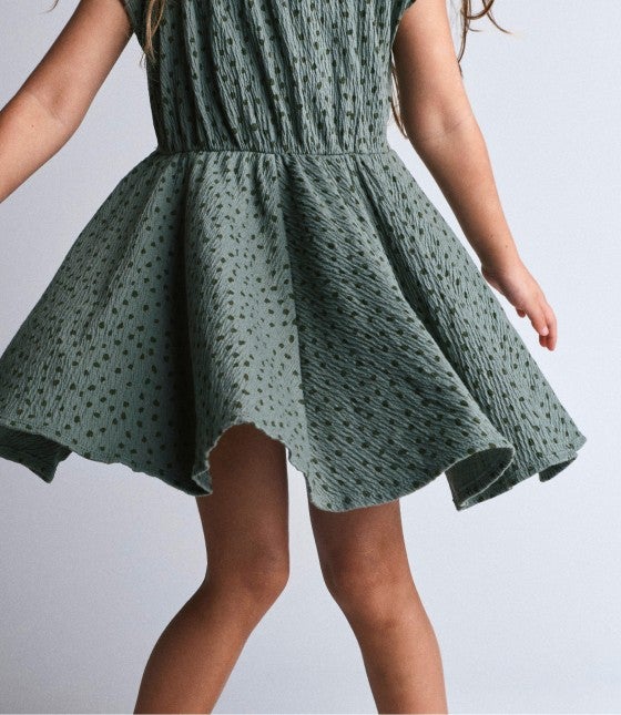 little girl twirling her dreess