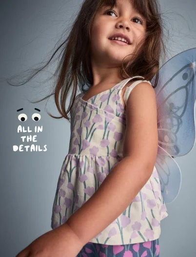 toddler girl in pattern tank and fairy wings