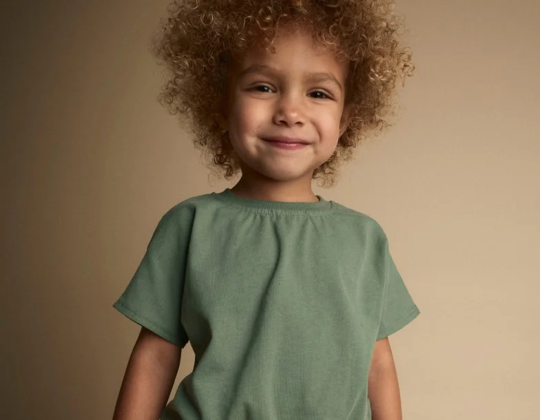 toddler girl in green tee