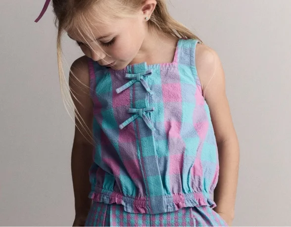 toddler girl in green polka dot top