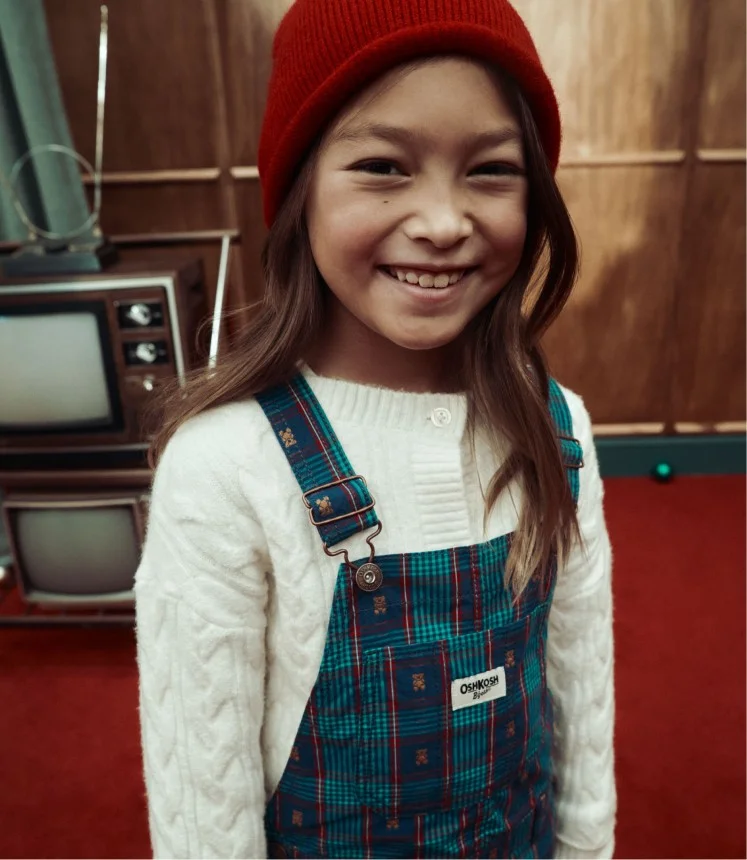 Girl in plaid overalls