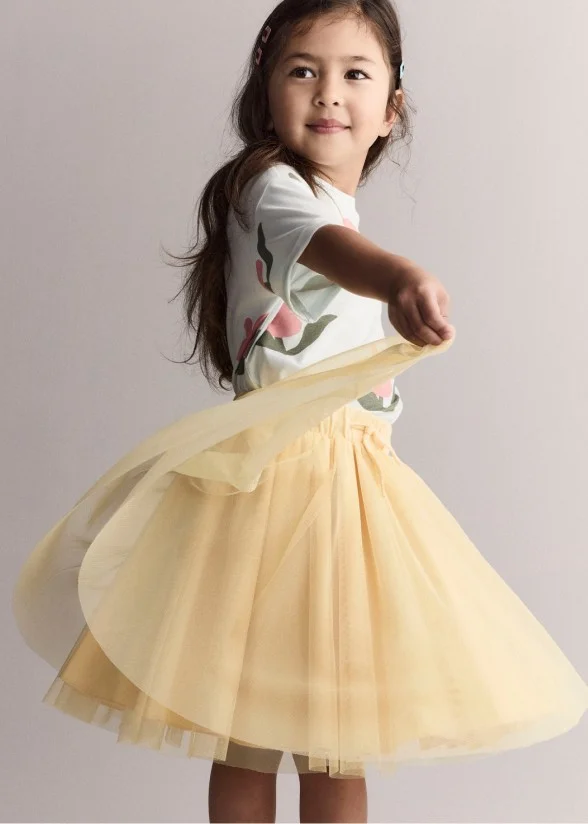 toddler girl twirling a dress