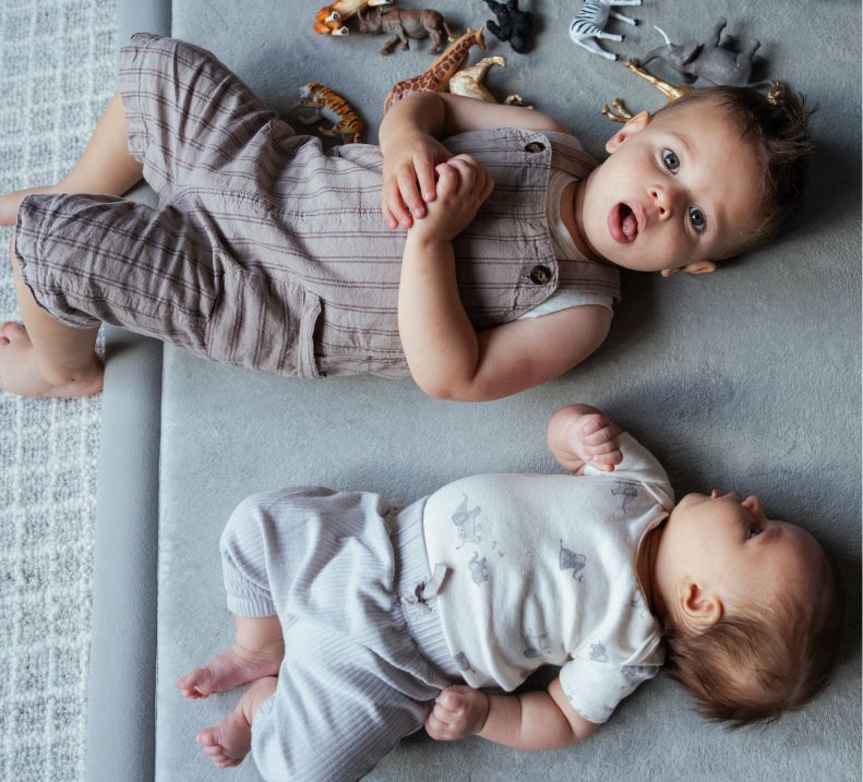 2 babies laying down