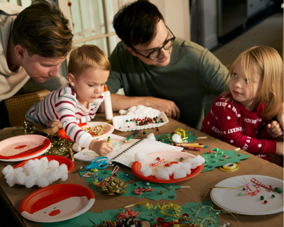 family doing crafts in holiday pajamas