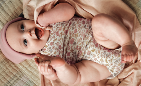 Smiling baby in floral onesie