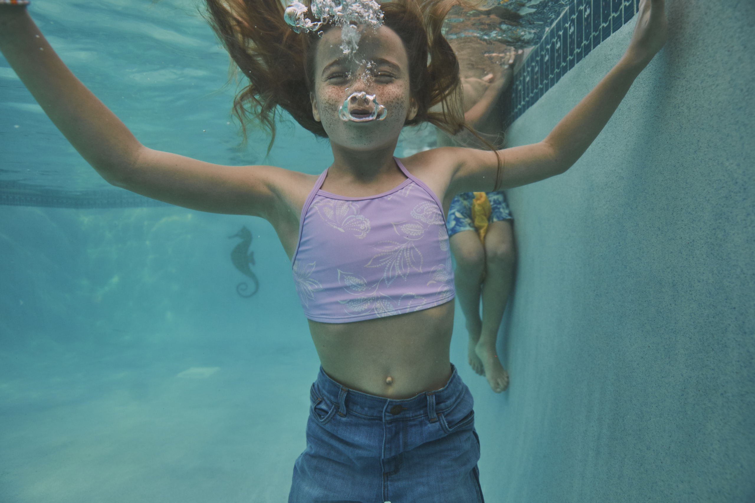Kid swimming under water