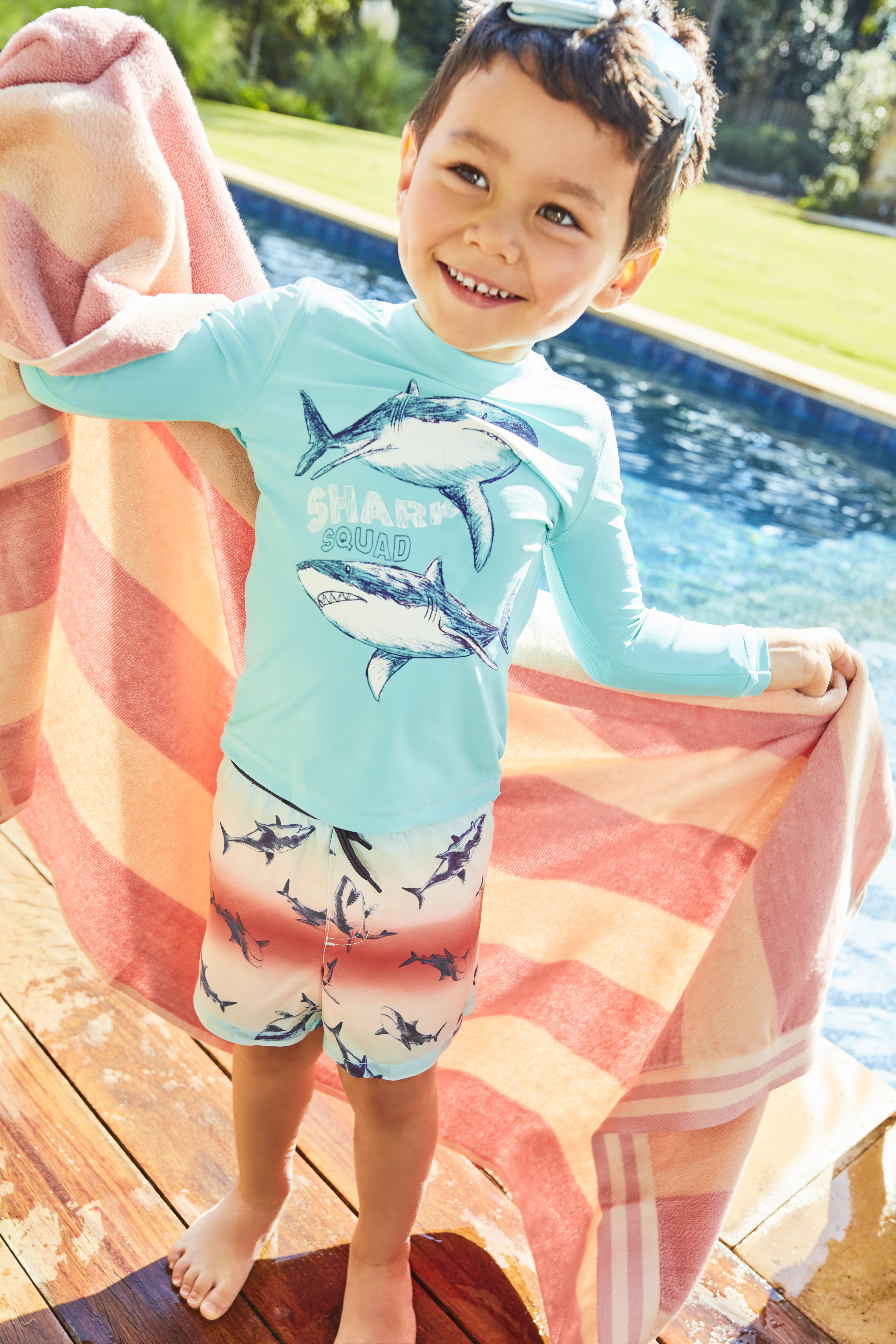 Kid with a towel at water park