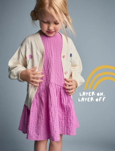 toddler girl in pink dress and cardigan