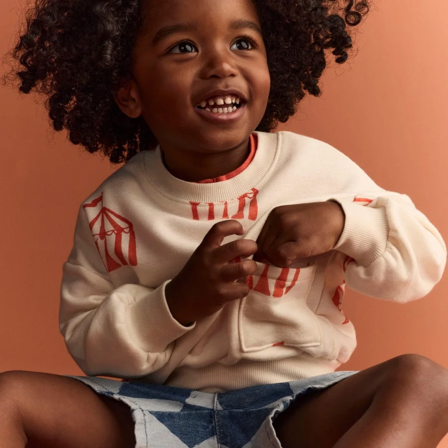 Toddler boy in graphic sweatshirt