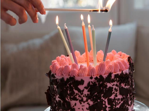A birthday cake being lit