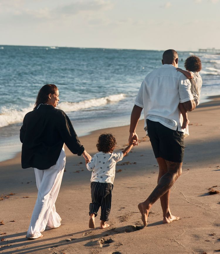 family walking on the beach
