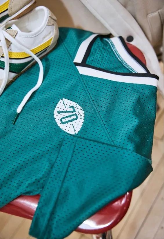 stack of folded clothes with shirt that says captain