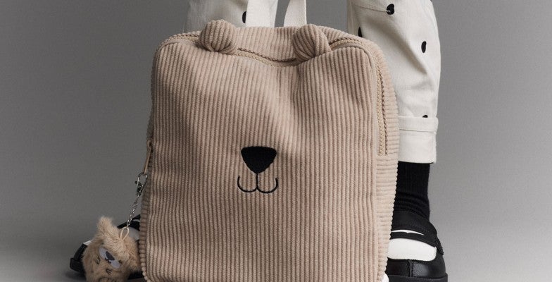 girl holding bag with face on it