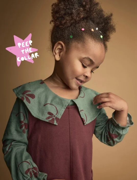 toddler girl in patterned dress with collar