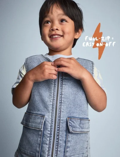 toddler boy in jean vest