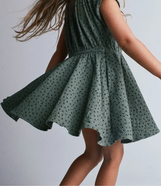 little girl twirling her dreess
