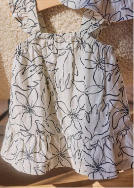 white and black dress hanging on a hanger