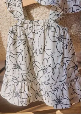 white and black dress hanging on a hanger