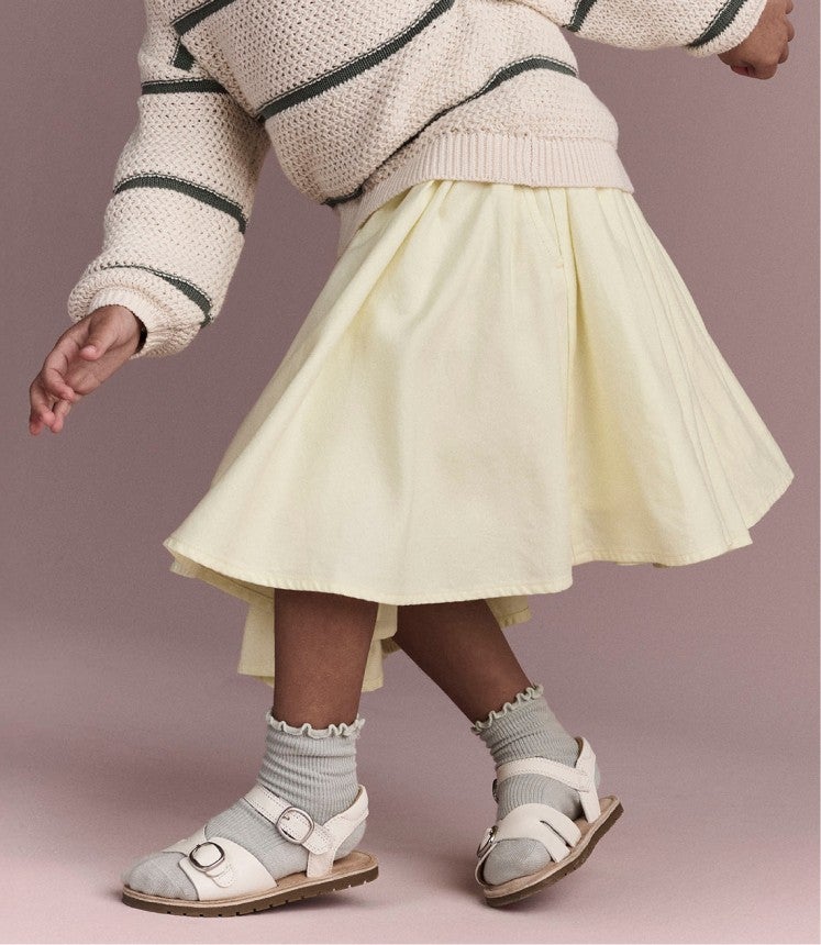 little girl twirling her skirt