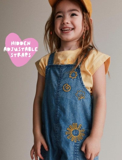 toddler girl in overalls