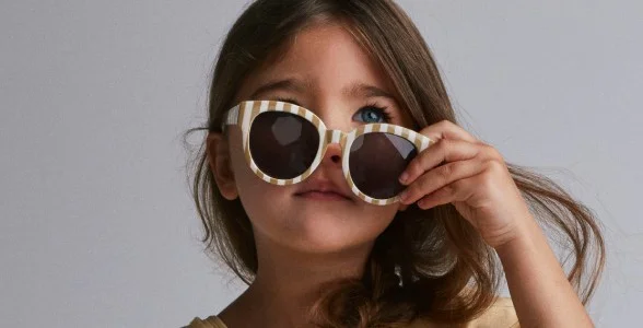 toddler girl holding striped sunnies