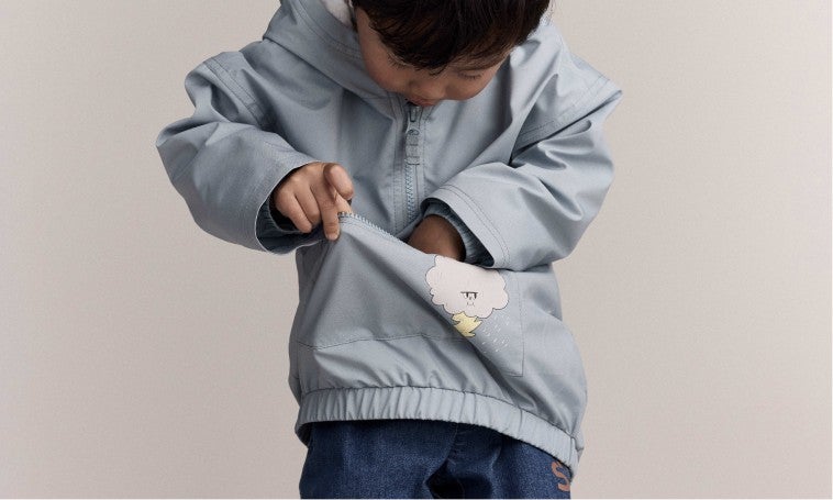 boy holding rain poncho