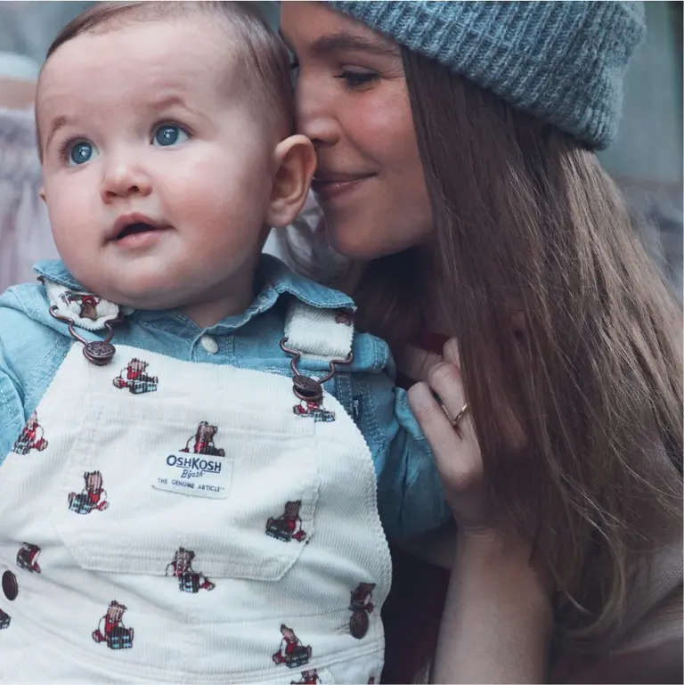 baby girl in printed overalls