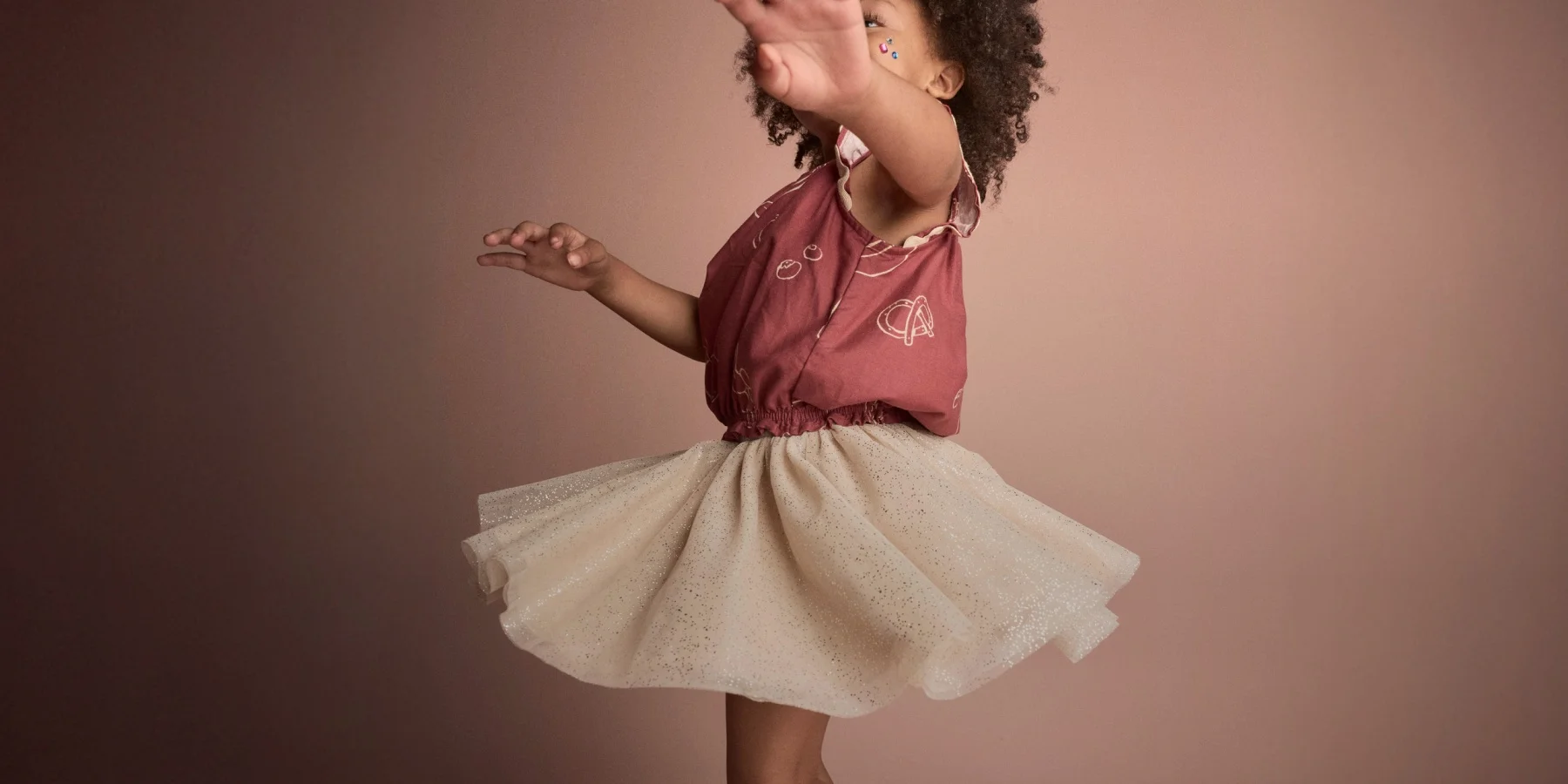 toddler kid twirling in flowy skirt