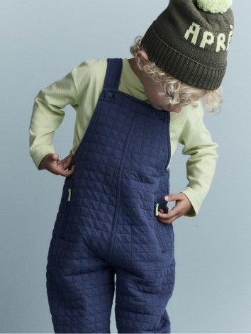 boy in otter avenue shirt and overalls