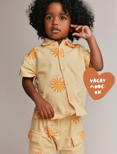 toddler boy in yellow matching set