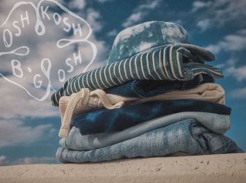 a stack of okb summer clothing