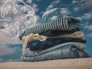 a stack of okb summer clothing