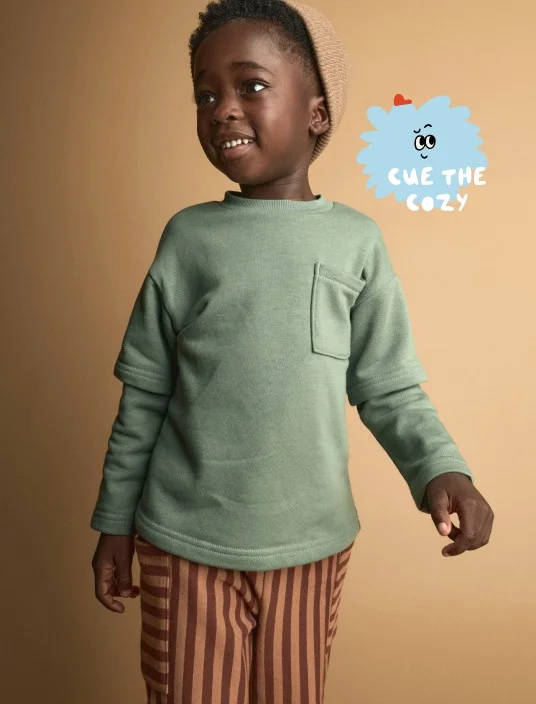 toddler boy in long sleeve and striped bottoms