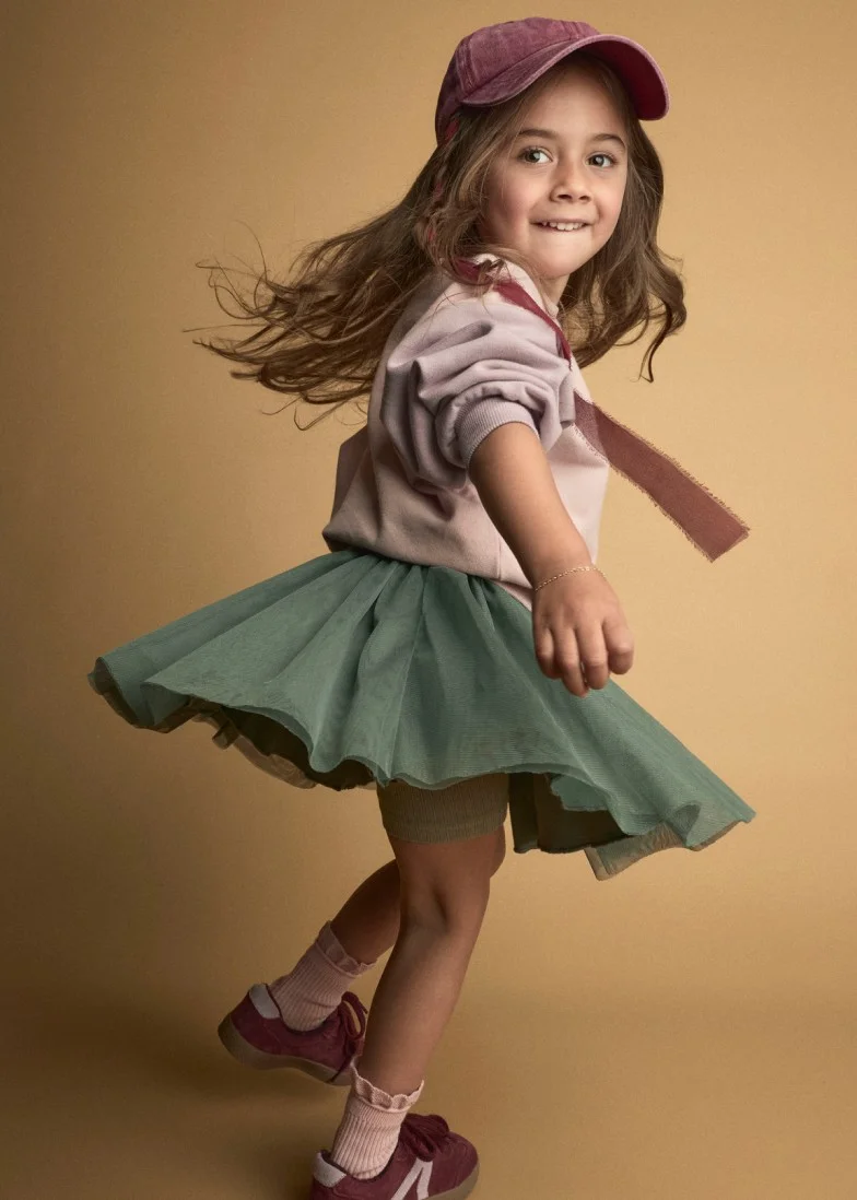 toddler girl twirling a skirt