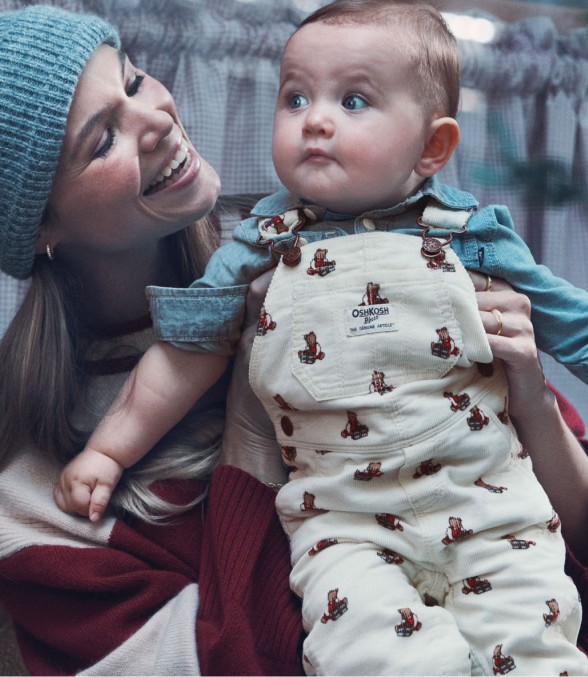 baby girl in printed overalls