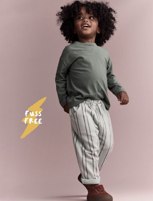Toddler boy dressed in printed pants