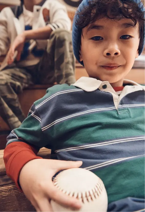 two boys sitting in gymnasium