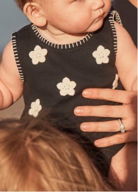 baby in a black floral outfit
