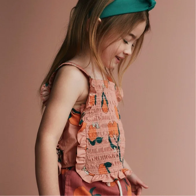 toddler girl in headband and patterned top